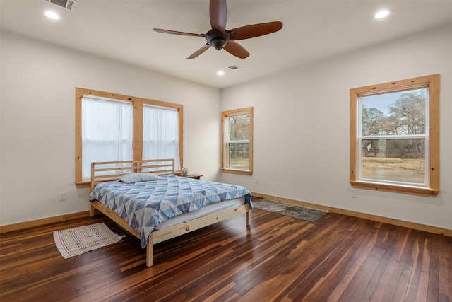 bedroom with dark hardwood / wood-style floors and ceiling fan