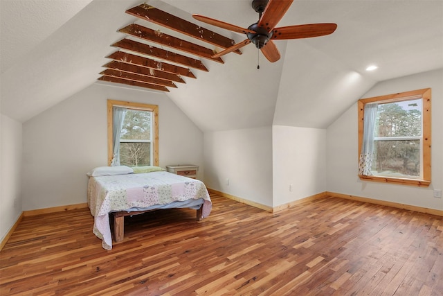 bedroom with vaulted ceiling, hardwood / wood-style floors, and ceiling fan