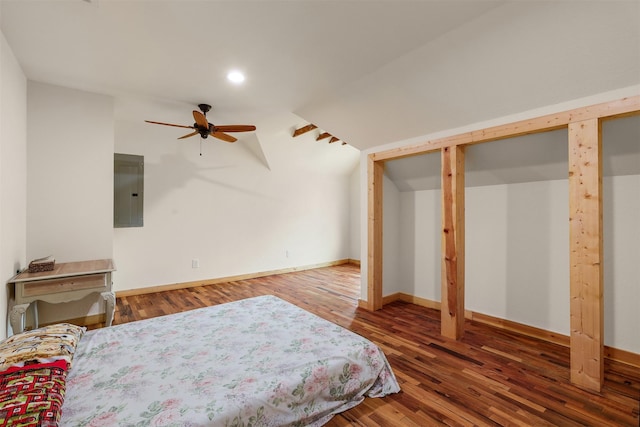 bedroom with electric panel and hardwood / wood-style floors