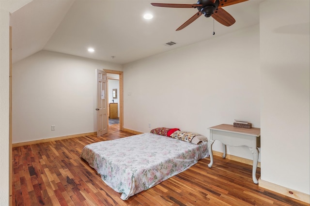 bedroom featuring hardwood / wood-style flooring and lofted ceiling