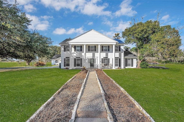 greek revival inspired property featuring a front lawn