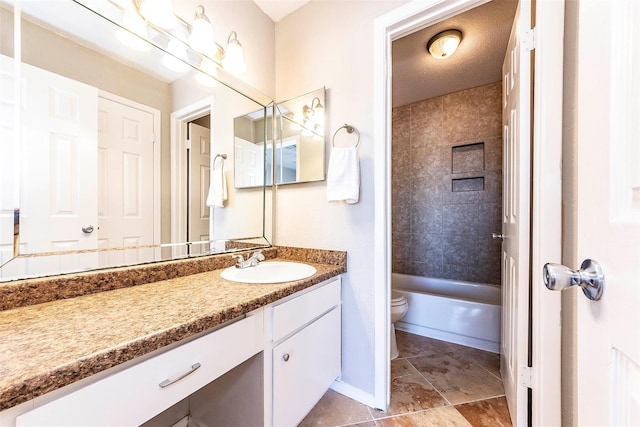 full bathroom with vanity, tiled shower / bath combo, and toilet