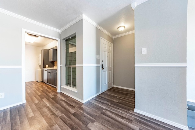 interior space featuring dark wood-type flooring, ornamental molding, and a textured ceiling