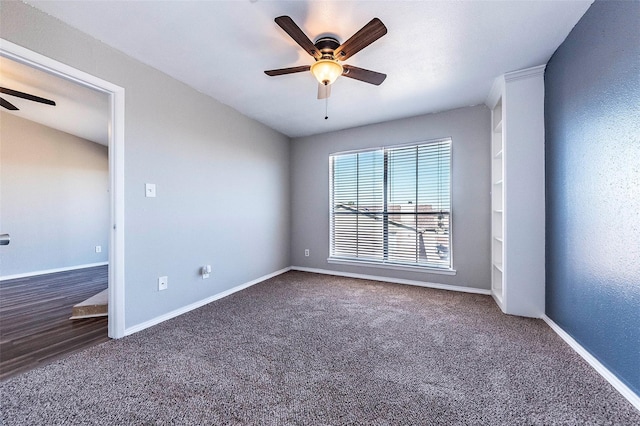 carpeted spare room featuring ceiling fan