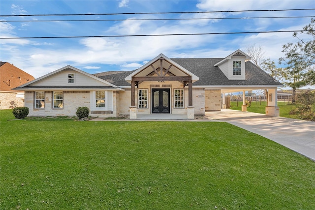 view of front of house with a carport, a front yard, and french doors