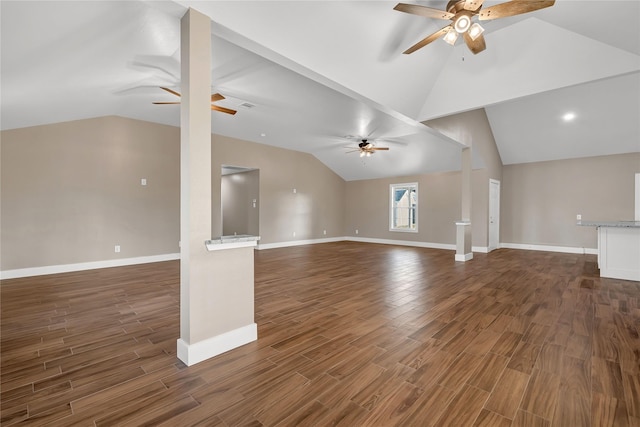 unfurnished living room with dark wood-type flooring, ceiling fan, and vaulted ceiling