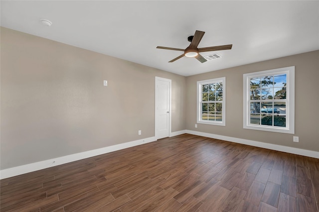 unfurnished room with dark hardwood / wood-style flooring and ceiling fan