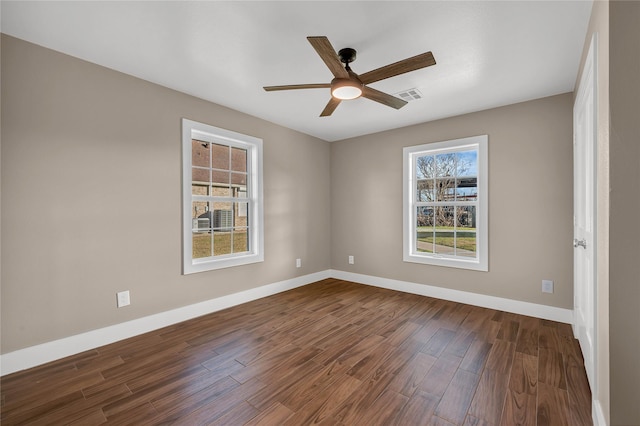 empty room with dark wood-type flooring and ceiling fan