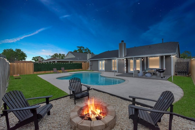 view of pool with a yard, a fire pit, and a patio