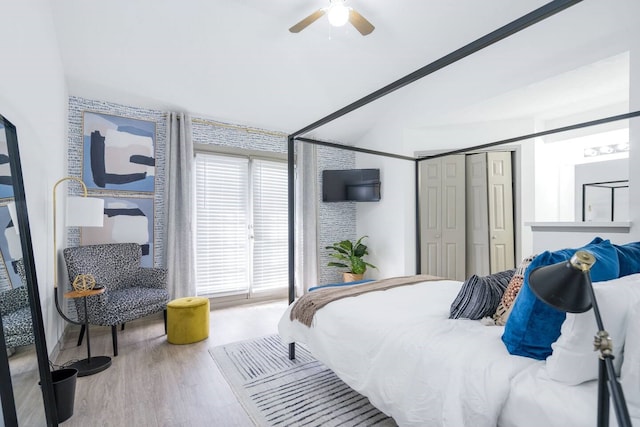 bedroom featuring lofted ceiling, hardwood / wood-style flooring, a closet, and ceiling fan