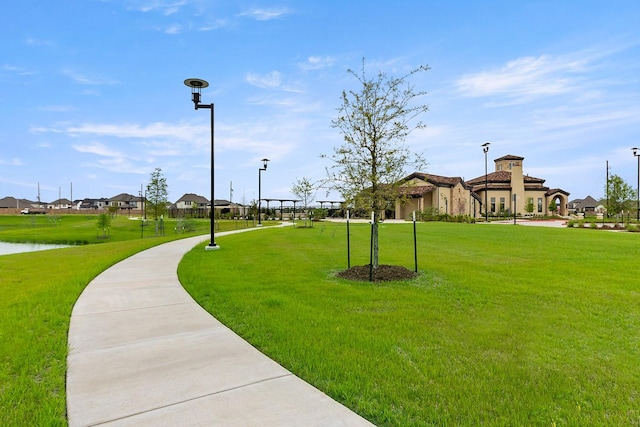 view of property's community featuring a water view and a lawn