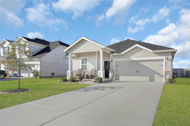 view of front of house with a garage, covered porch, and a front lawn