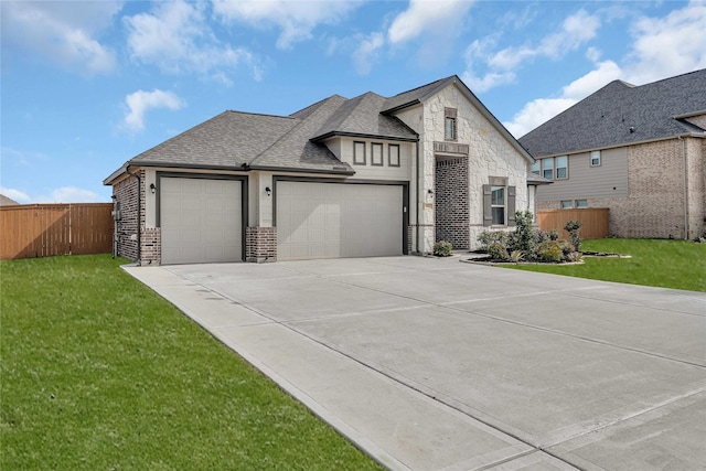 view of front of house featuring a garage and a front lawn