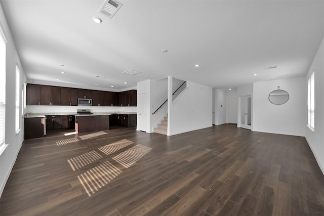 unfurnished living room with dark hardwood / wood-style floors