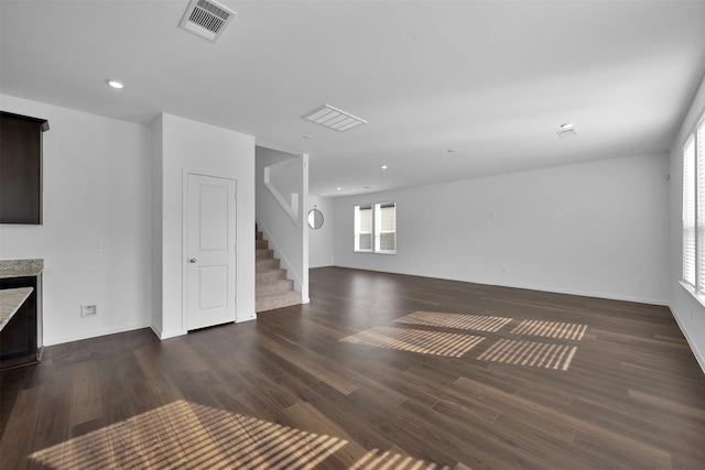 unfurnished living room with dark hardwood / wood-style floors