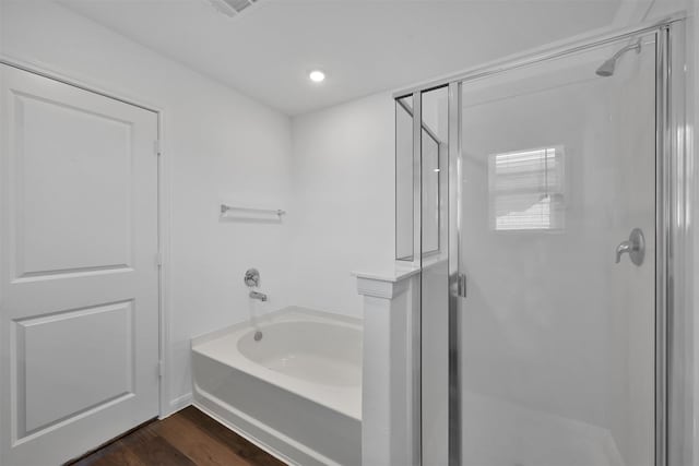 bathroom featuring hardwood / wood-style floors and separate shower and tub