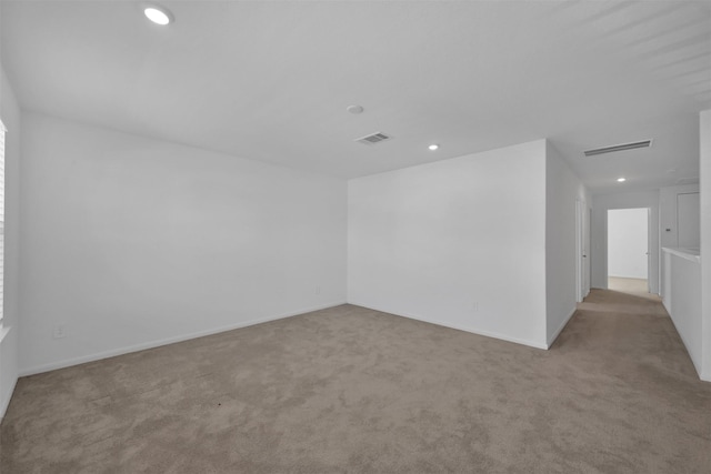 spare room featuring light colored carpet