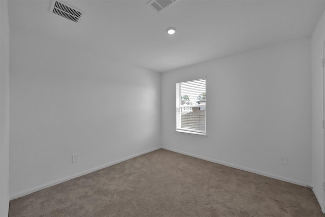 unfurnished room featuring light carpet