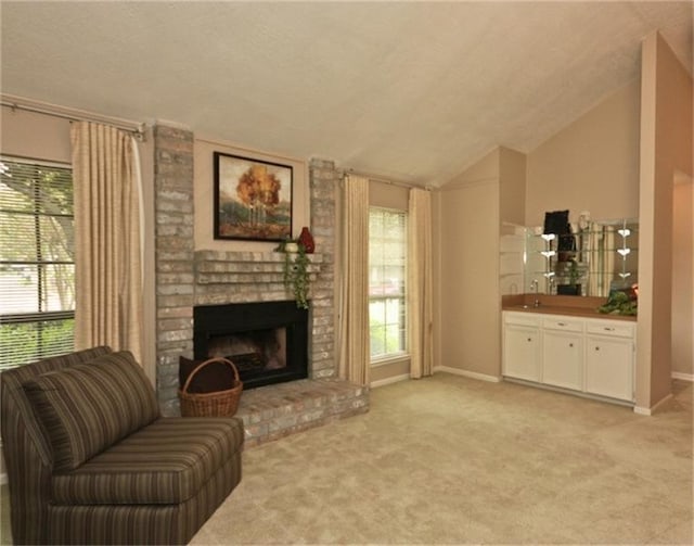 living area with vaulted ceiling, light colored carpet, and a fireplace