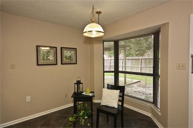 tiled dining area with a textured ceiling