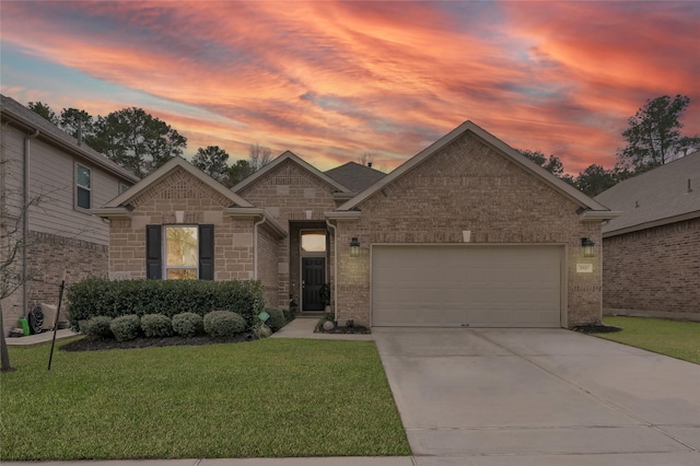 view of front of property featuring a garage and a lawn