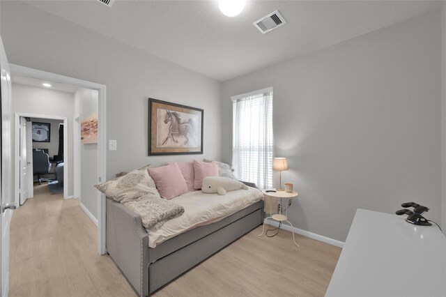 bedroom with light wood-type flooring