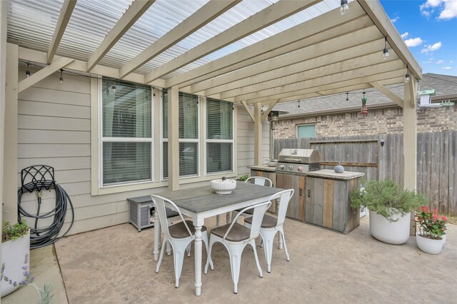 view of patio / terrace with area for grilling and a pergola