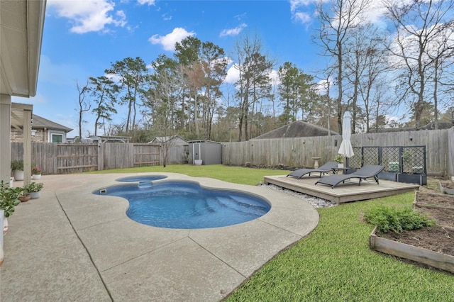 view of pool with an in ground hot tub, a yard, a wooden deck, and a storage shed