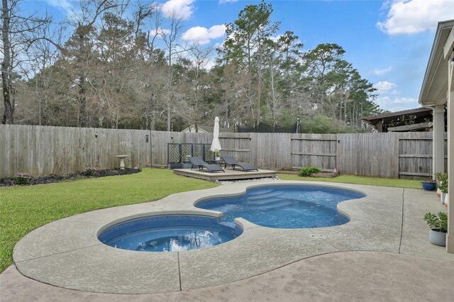 view of pool featuring a patio, a wooden deck, a yard, and an in ground hot tub