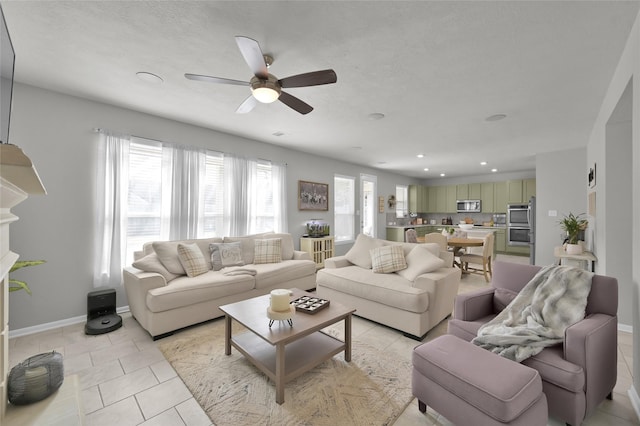 living room with light tile patterned floors and ceiling fan