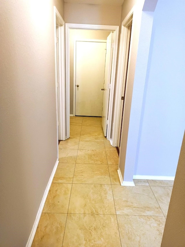 hallway with light tile patterned floors