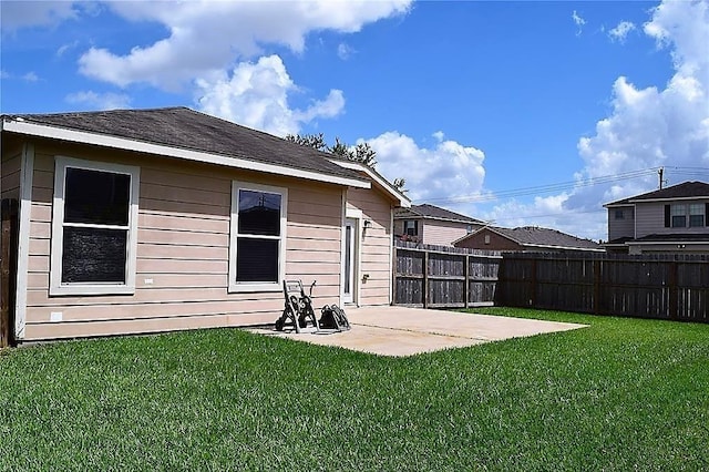 rear view of property featuring a patio and a lawn