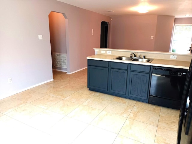 kitchen with blue cabinets, dishwasher, sink, and light tile patterned flooring