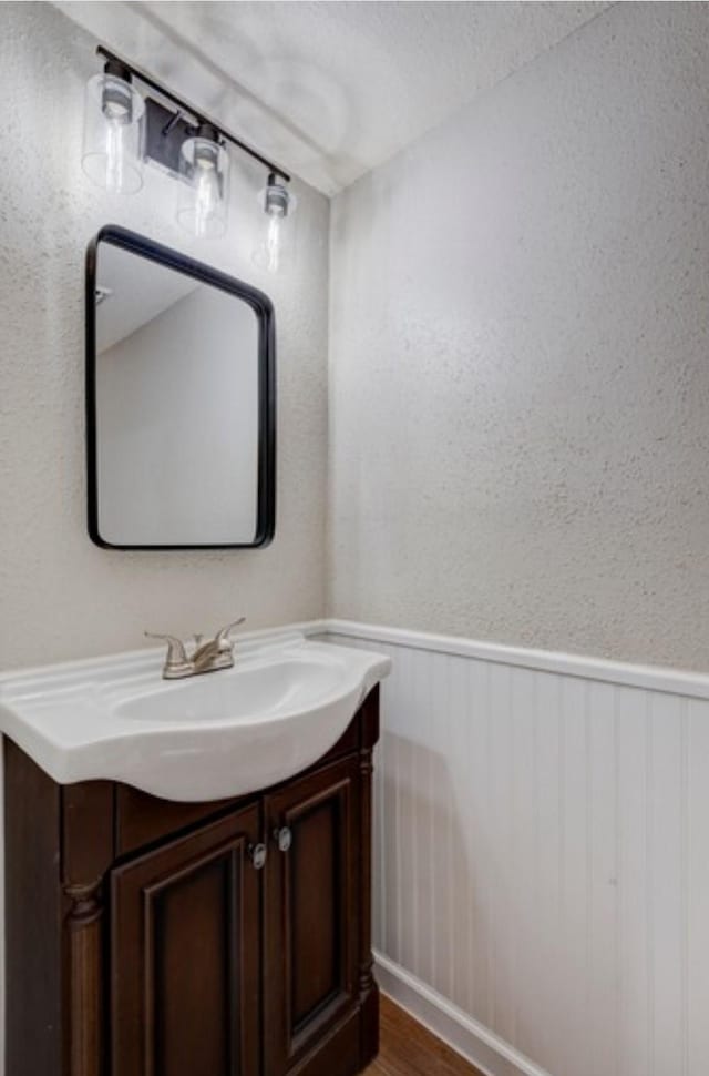 bathroom with vanity and hardwood / wood-style floors