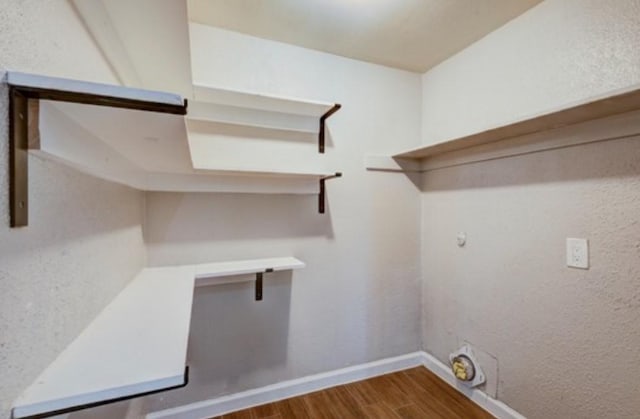 laundry area with wood-type flooring