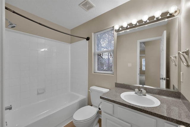 full bathroom with vanity, shower / washtub combination, a textured ceiling, and toilet