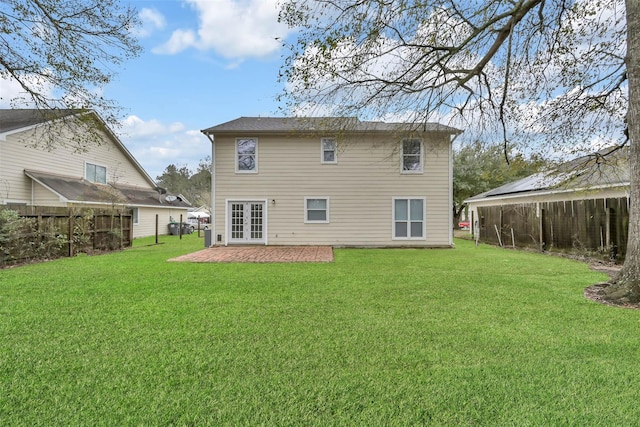 back of property with french doors, a yard, and a patio