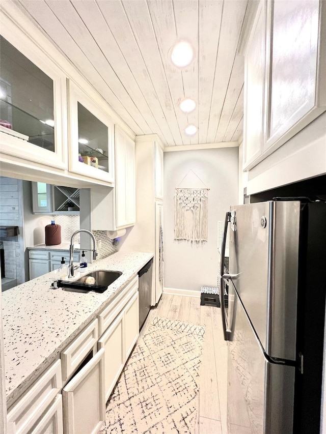 kitchen featuring sink, wood ceiling, stainless steel appliances, light stone counters, and light hardwood / wood-style floors