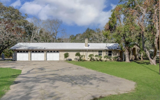 single story home featuring a garage and a front yard