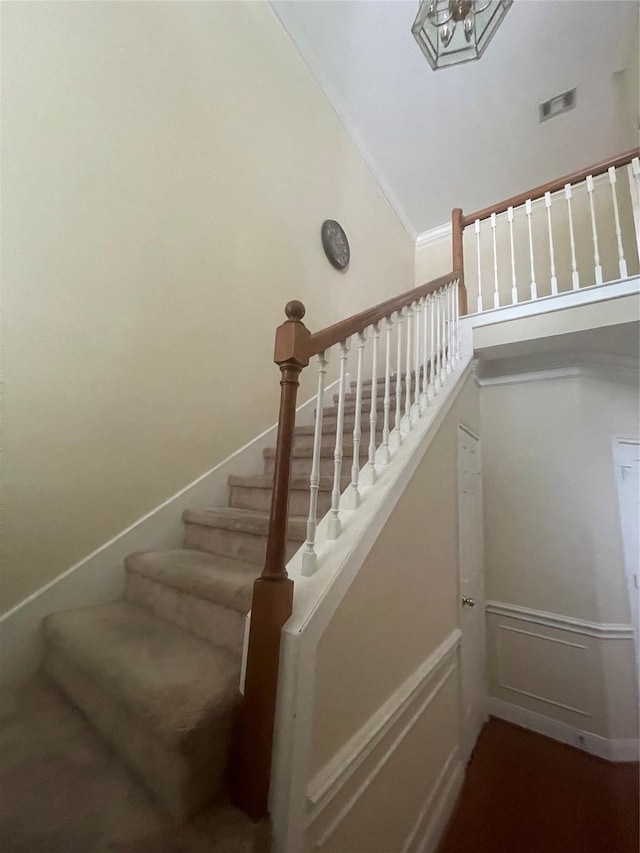 staircase featuring vaulted ceiling