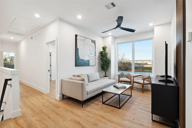 living room with a wealth of natural light, ceiling fan, and light wood-type flooring