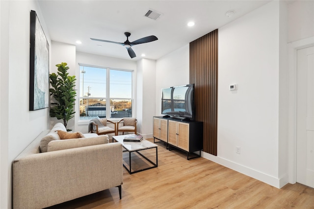 living room featuring light hardwood / wood-style floors and ceiling fan