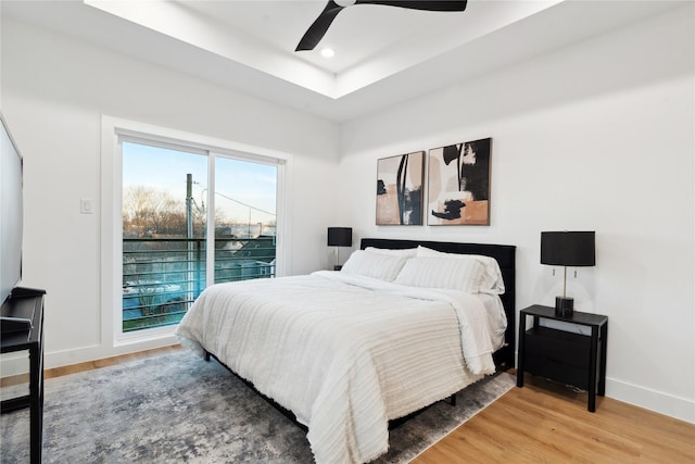 bedroom featuring wood-type flooring, access to outside, and ceiling fan