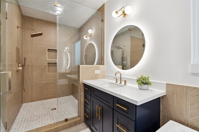 bathroom featuring vanity and a shower with shower door