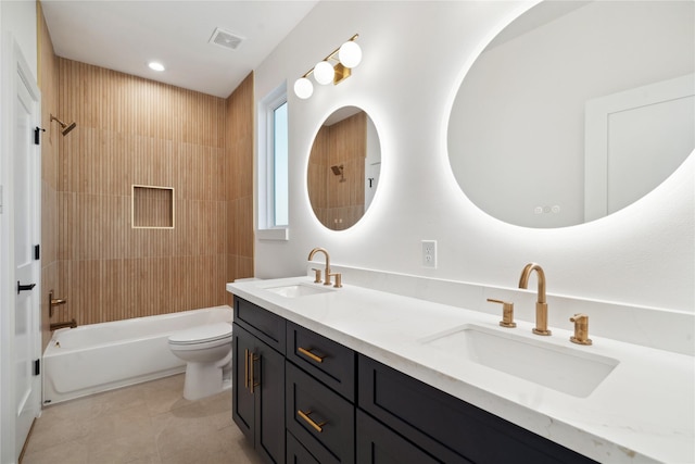 full bathroom featuring vanity, tiled shower / bath combo, and toilet