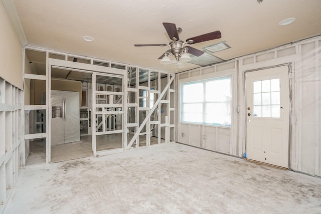 unfurnished living room with ceiling fan