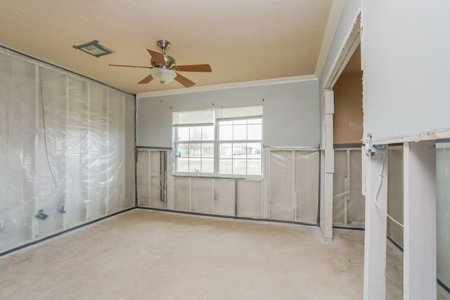 unfurnished room featuring ceiling fan and ornamental molding