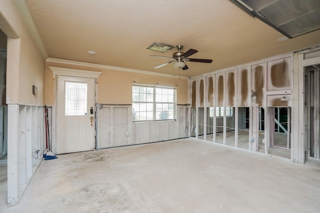 unfurnished room with a textured ceiling, ornamental molding, and ceiling fan