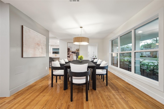 dining space with light wood-type flooring