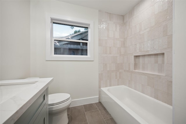 full bathroom with vanity, tiled shower / bath, and toilet